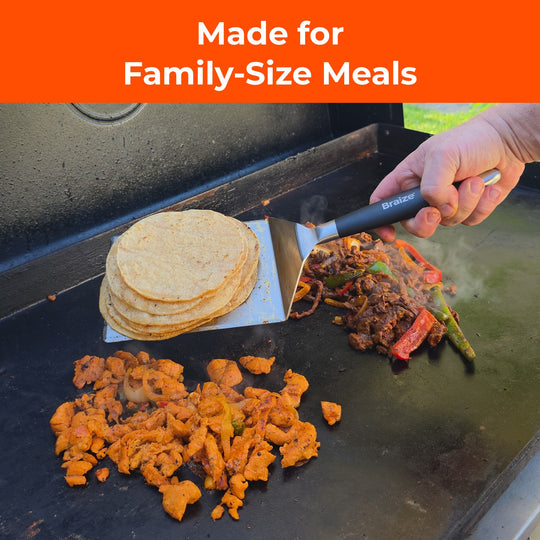 Wide griddle spatula holding a stack of tortillas